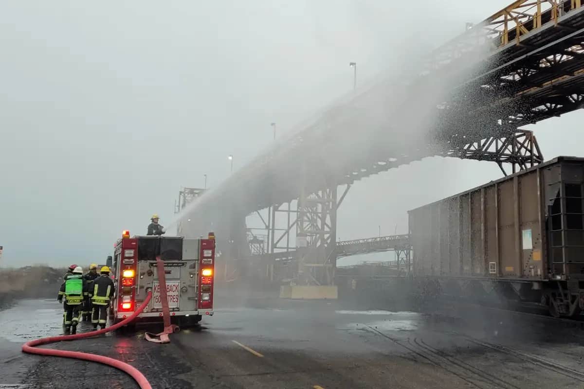 firemen spraying water on a bridge
