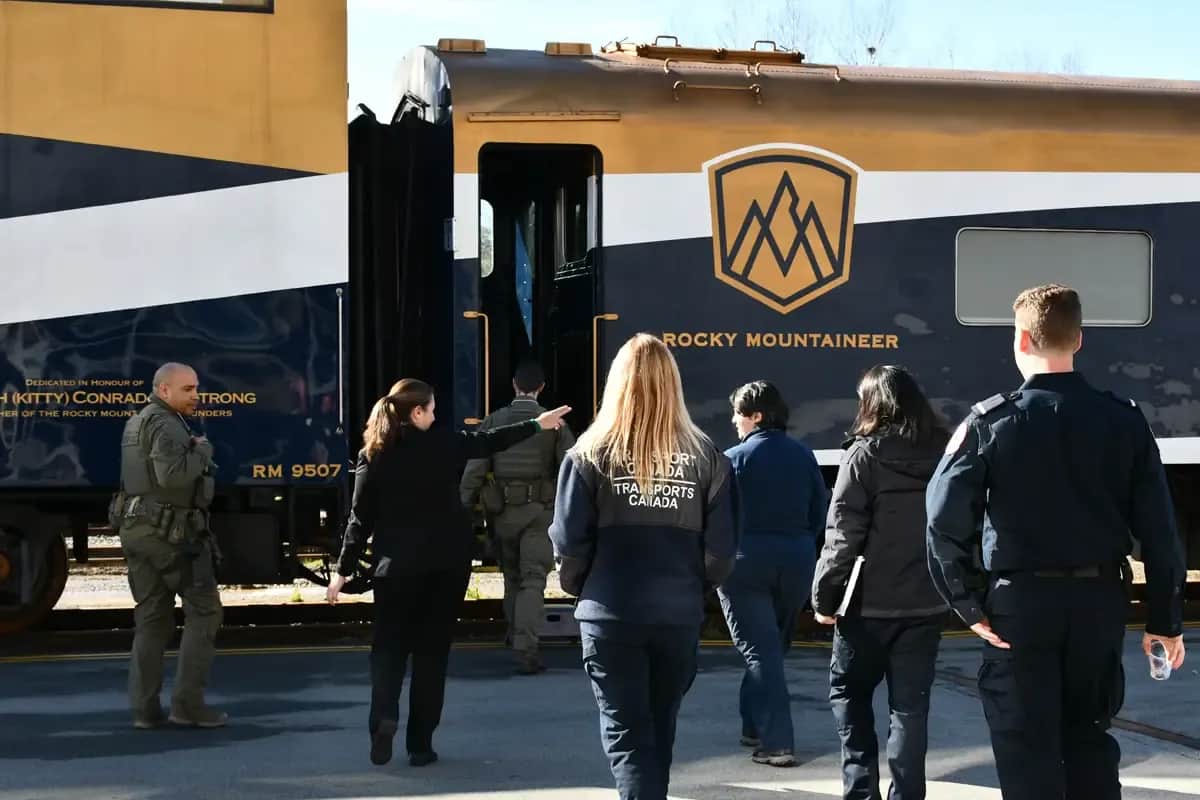a group of people walking by a train