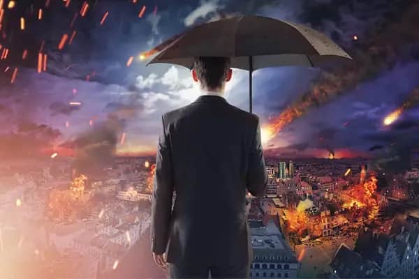 a man holding an umbrella looking at a city