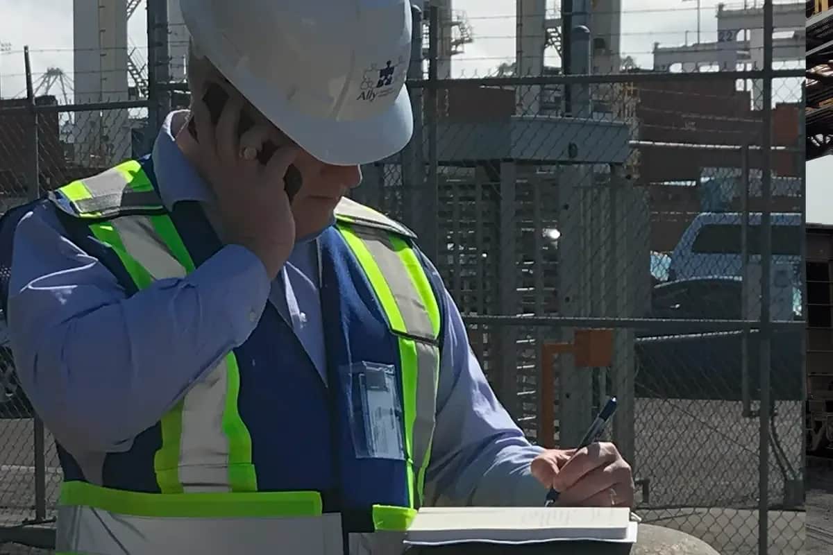 a man in a hard hat talking on a cell phone