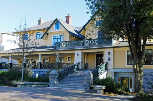 A large house with stairs leading to the front