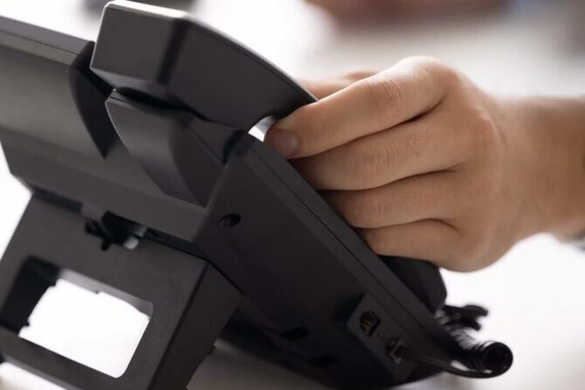 Hand,Of,Businessman,Touching,Handset,Of,Office,Landline,Phone.,Office